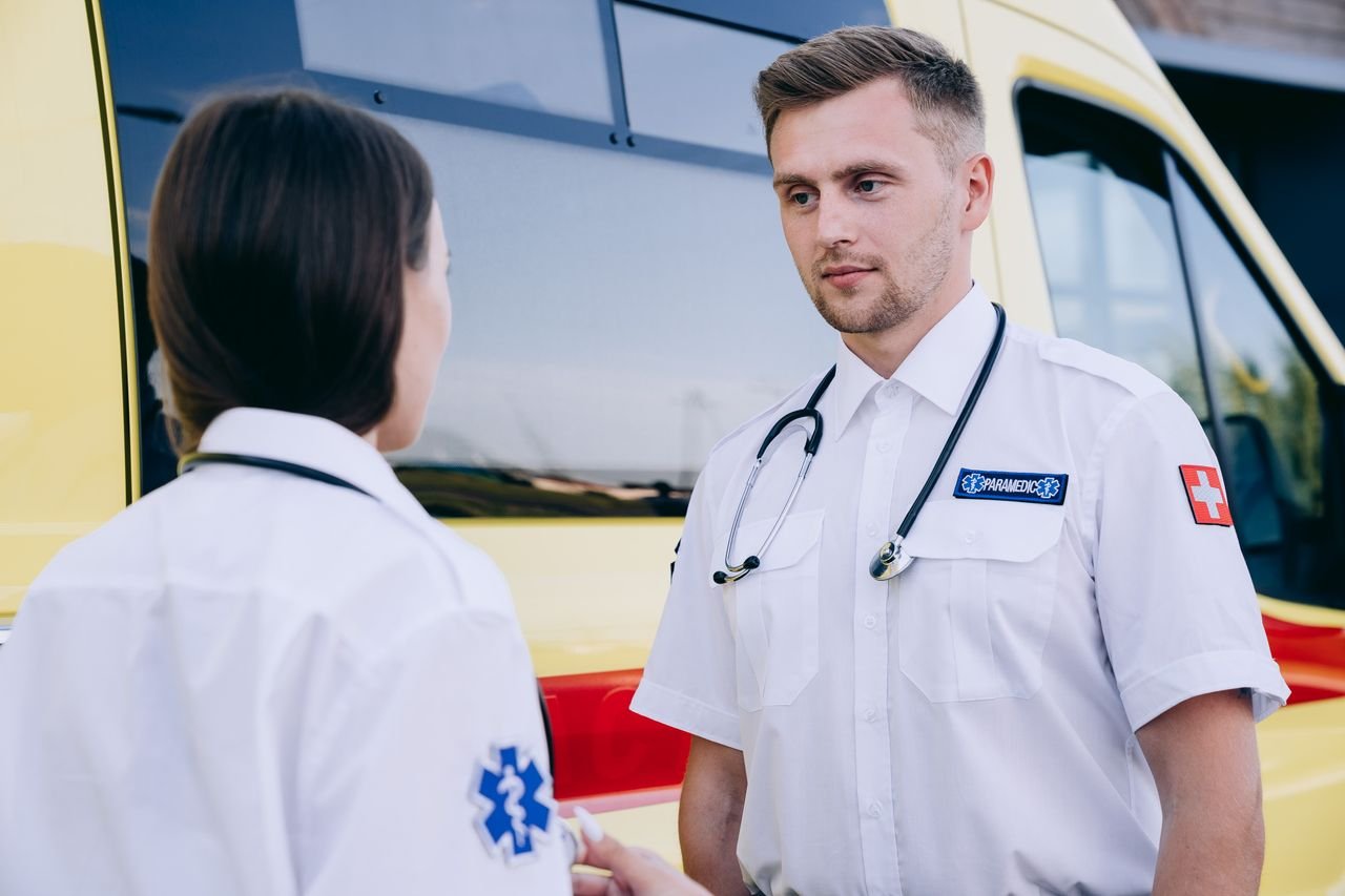 Crafting Captivating Headlines: Your awesome post title goes here Two paramedics in uniform discussing beside an ambulance during daytime.