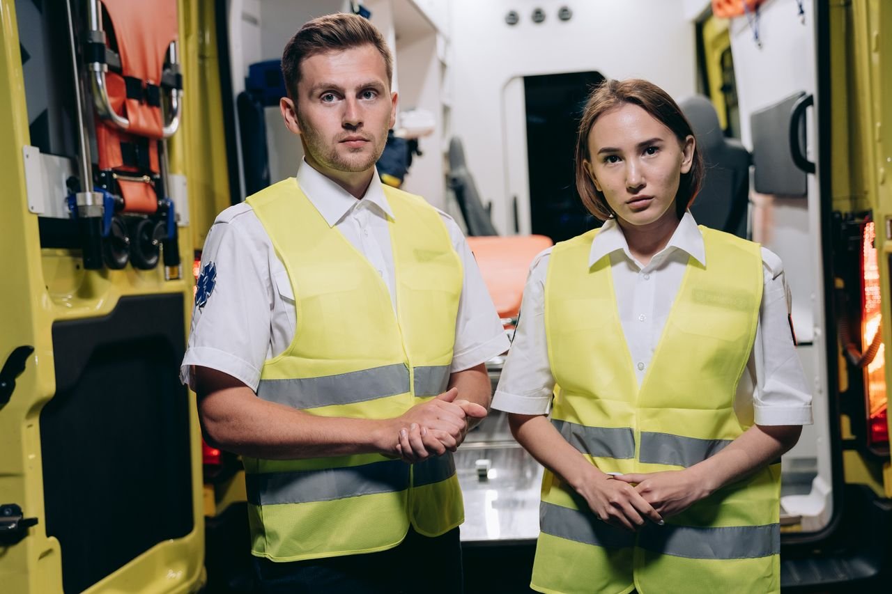 The Art of Drawing Readers In: Your attractive post title goes here Two paramedics in vests prepare for action inside an ambulance, showcasing readiness and professionalism.