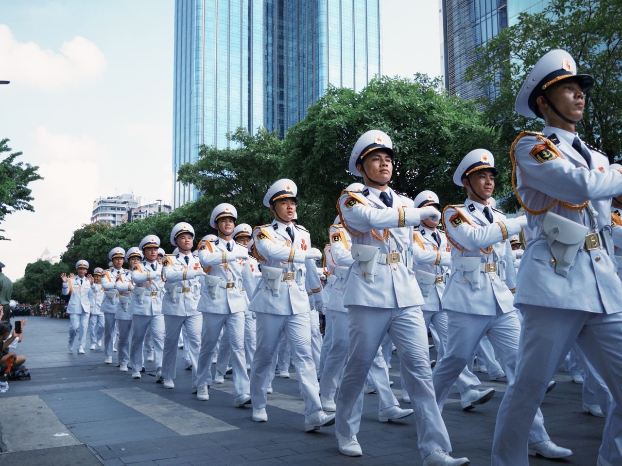 Services Group of uniformed officers marching in a city parade.